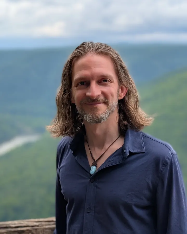 Brandon Pearce, who built Well Lived, on a ridge above a green valley